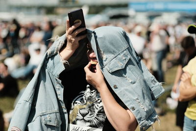 Midsection of woman photographing with mobile phone