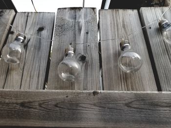 Low angle view of light bulbs hanging on table