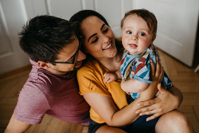 Happy family sitting at home