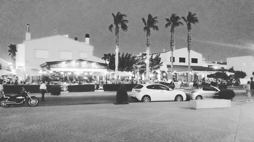 Cars on street against buildings in city