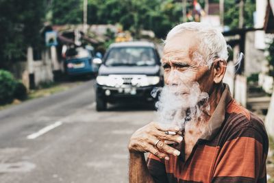 Portrait of man on road in city