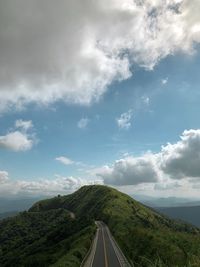 Empty road on mountain against sky