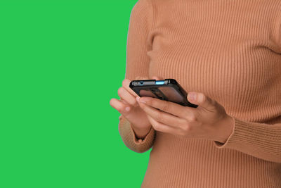 Midsection of woman using mobile phone