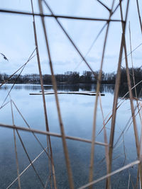 Bridge over river against sky during winter