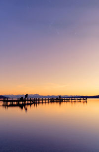 Scenic view of lake against sky at sunset