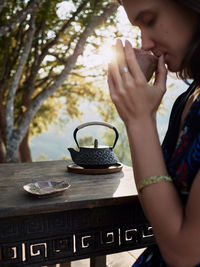 Woman drinking tea in garden