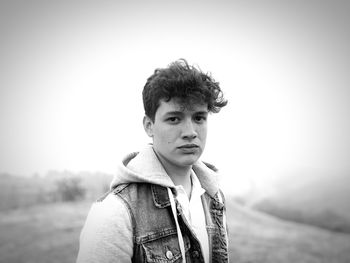 Portrait of young man standing against clear sky