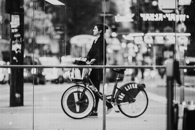 Bicycles on street seen through glass window