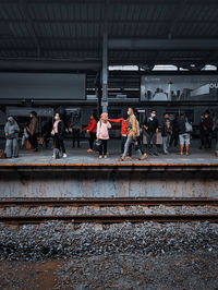 People waiting at railroad station platform