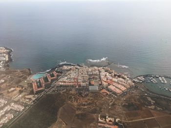 High angle view of buildings and sea in town