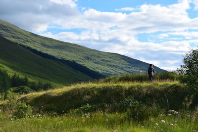 Low angle view of green landscape against sky