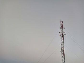 Low angle view of electricity pylon against sky