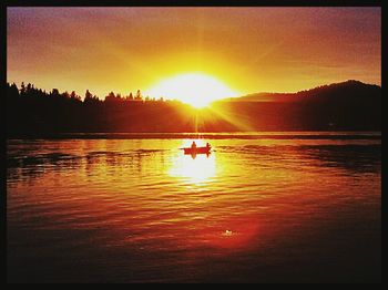 Scenic view of lake at sunset