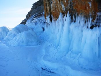 Panoramic view of frozen rock against sky