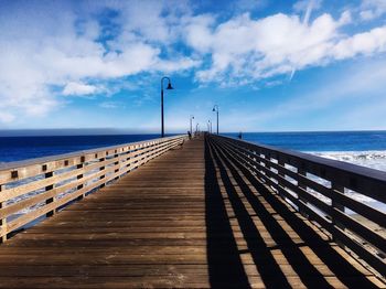 Pier over sea against sky