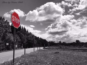 Road sign against sky