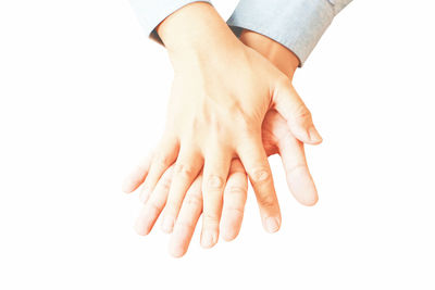 Close-up of hand holding hands over white background