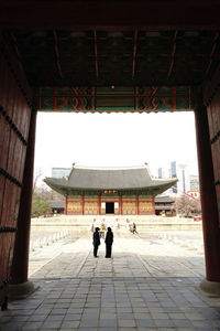 Rear view of people walking in a building