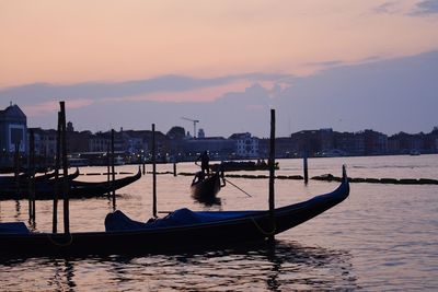 Boat in canal at sunset