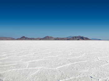 Panoramic view of the stark white bonneville salt flats with mountains in the distance