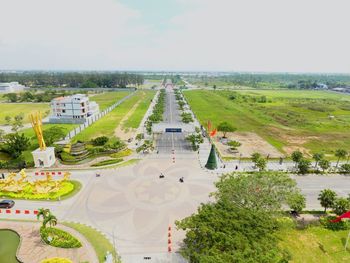 High angle view of road amidst trees and buildings against sky