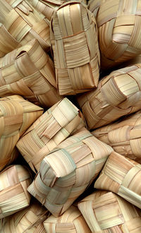 Several piles of ketupat in a basket.