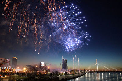 Low angle view of firework display at night