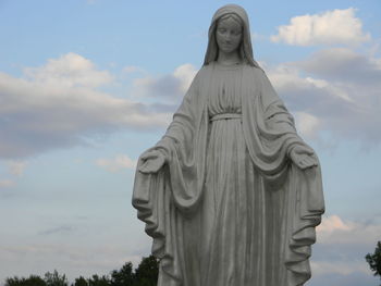 Low angle view of statue against sky