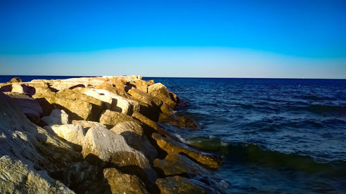 Scenic view of sea against clear blue sky