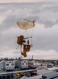 Boats in sea against cloudy sky