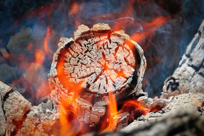 Close-up of bonfire against orange sky