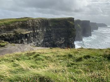 Scenic view of waterfall against sky