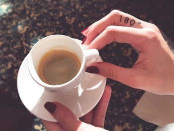 Midsection of woman holding coffee cup