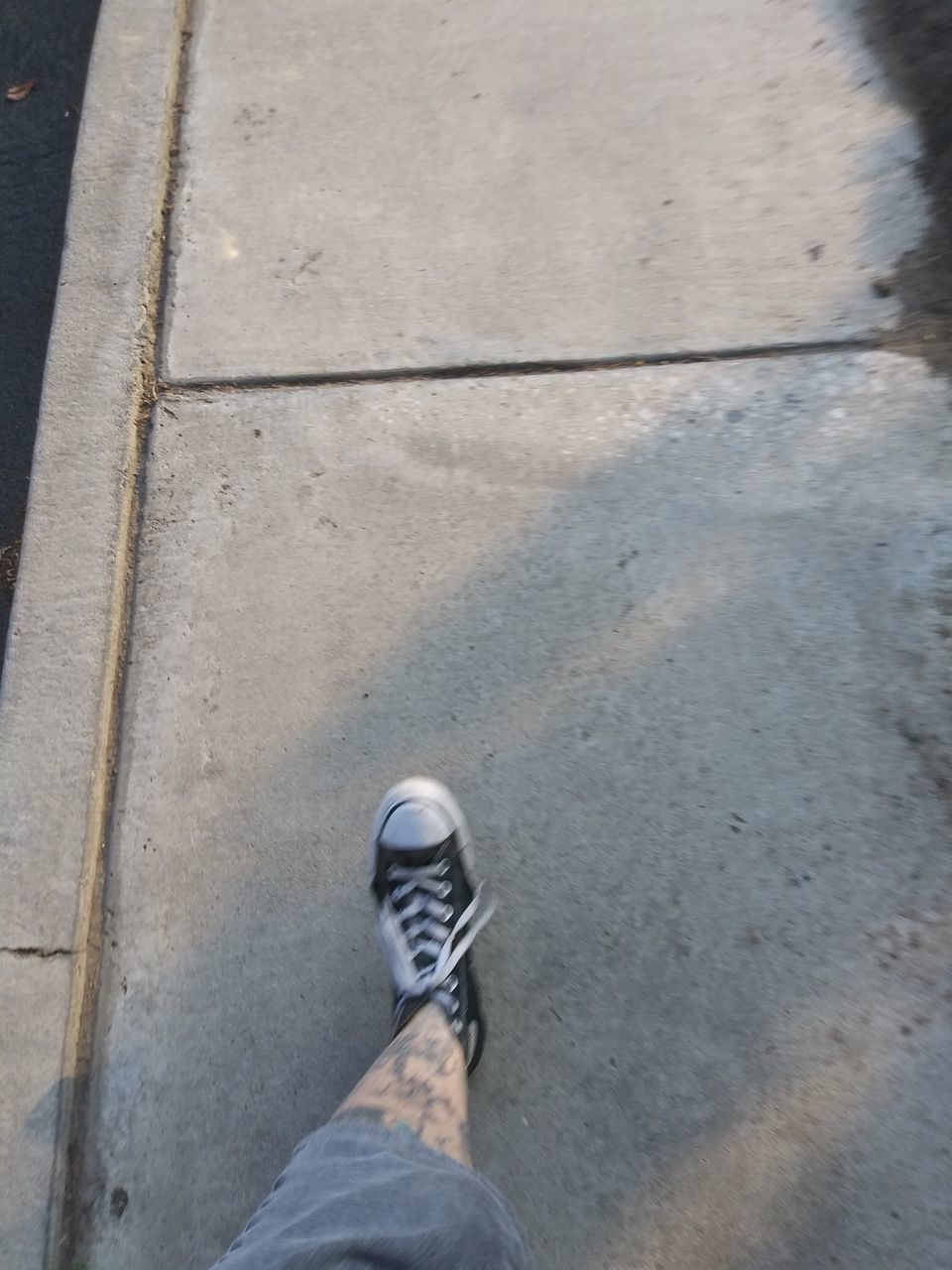 LOW SECTION OF MAN STANDING ON STREET