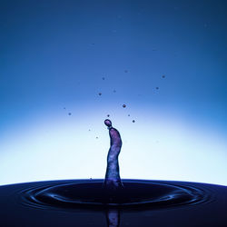 Close-up of water splashing against blue background