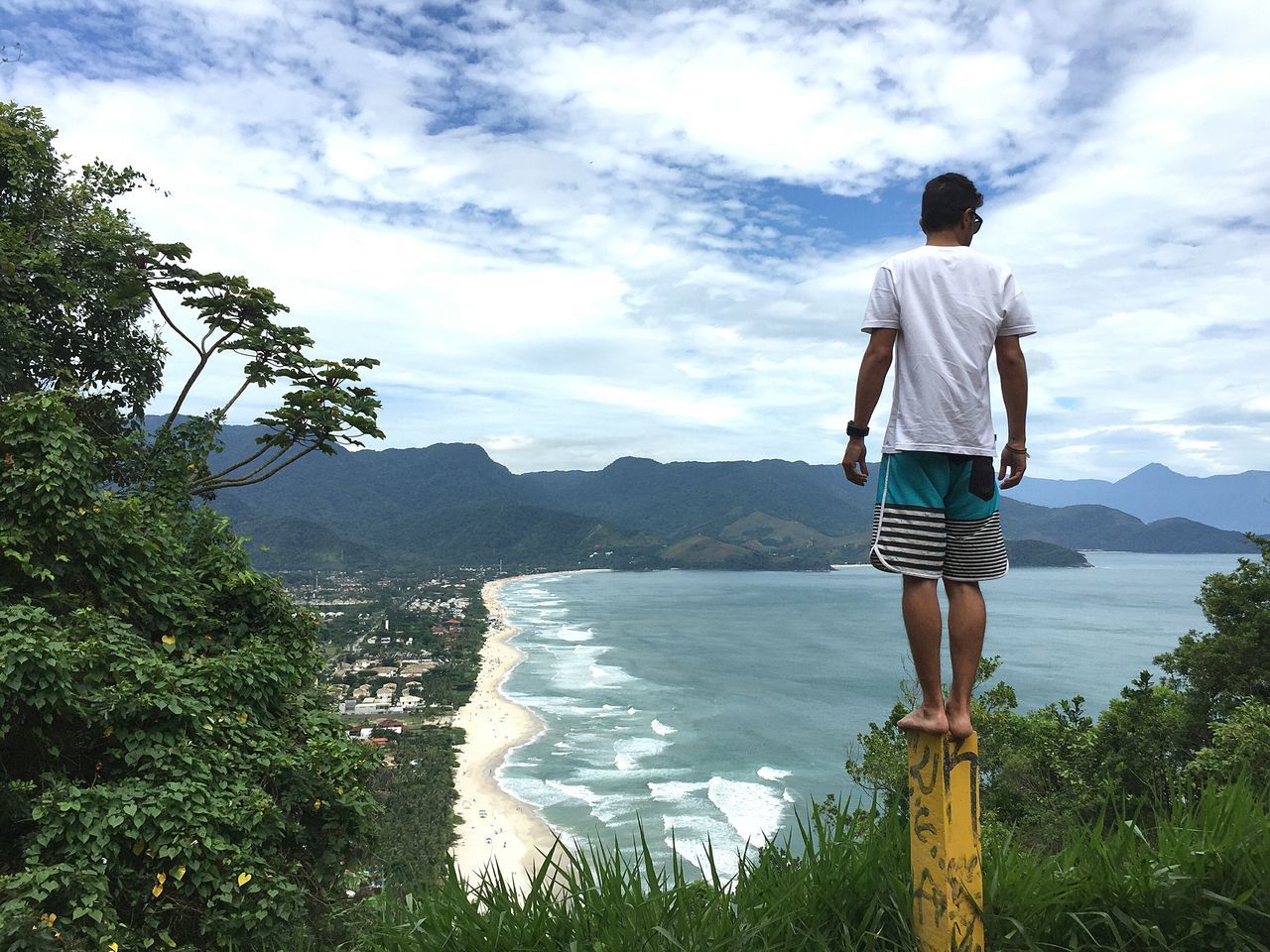 sky, rear view, mountain, water, standing, full length, casual clothing, cloud - sky, lifestyles, leisure activity, tranquil scene, tranquility, cloud, nature, sea, scenics, beauty in nature, men