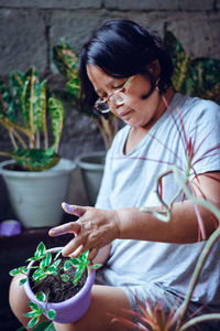 Woman holding potted plant