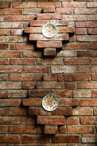 Close-up of clock on brick wall