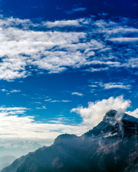 Low angle view of mountains against blue sky