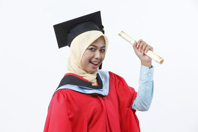 Portrait of a smiling young woman against white background