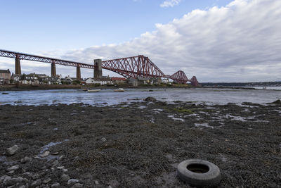 View of bridge over river against cloudy sky