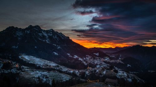 Scenic view of snowcapped mountains against sky during sunset