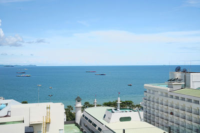 High angle view of sea by buildings against sky