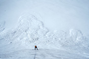 PERSON SKIING IN SNOWY MOUNTAIN