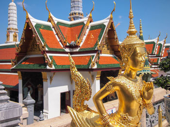 Low angle view of statue against temple building