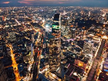 High angle view of city lit up at night