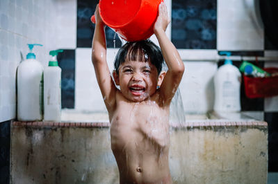 Portrait of shirtless boy in park