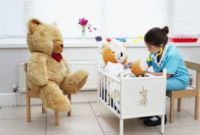 Stuffed toy with toys sitting on floor
