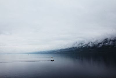 Scenic view of sea against cloudy sky