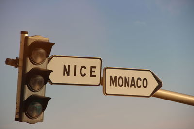 Low angle view of road sign against sky